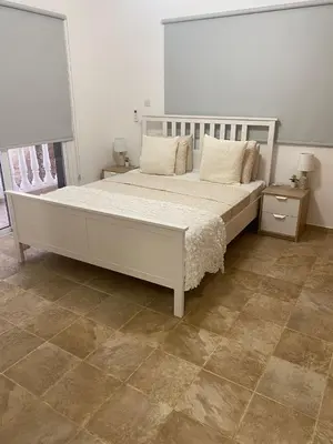 a bedroom with a large white bed and a tile floor at Villa suncity Boutique Beachfront in Ayia Napa