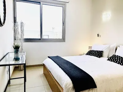 a bedroom with a bed and a glass table at The Penthouse 401 in Larnaka