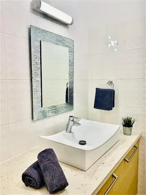 a bathroom with a sink and a mirror at The Penthouse 401 in Larnaka