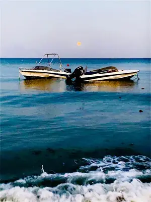 two boats sitting on the water in the ocean at The Penthouse 401 in Larnaka