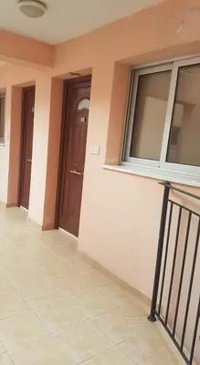 a hallway of a building with a door and windows at Andris apartment in Paralimni