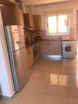 a kitchen with a stainless steel refrigerator and a dishwasher at Andris apartment in Paralimni