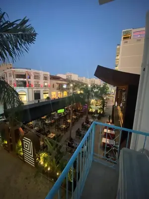 a view of a city street with tables and buildings at 2 bedroom apt in Ermou 4 minute walk beach in Larnaka