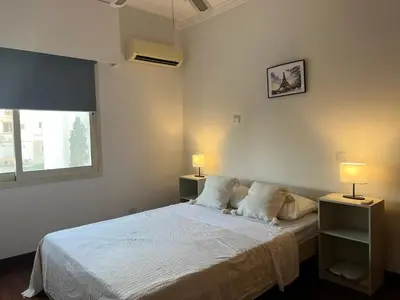 a bedroom with a white bed and two lamps at SEA VIEW AMATHUS LUXURY APT in Limassol