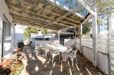 a patio with a table and chairs under a pergola at Blossom Holiday Villa DPS18 in Protaras