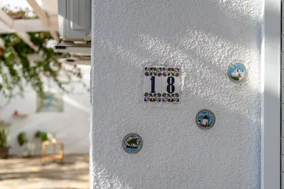a white door with a clock on it with magnets at Blossom Holiday Villa DPS18 in Protaras