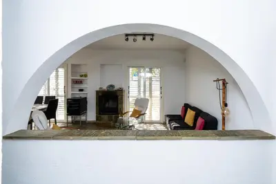 an archway in a living room with a couch at Blossom Holiday Villa DPS18 in Protaras