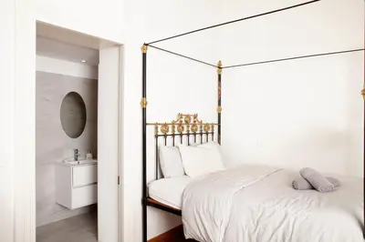 a bedroom with a black and white canopy bed at MeMeraki Artist Residency in Limassol