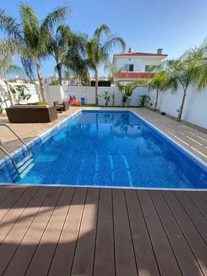 a swimming pool in a villa with palm trees at Villa Angel - Exotic Villa 200m From Beach in Paralimni