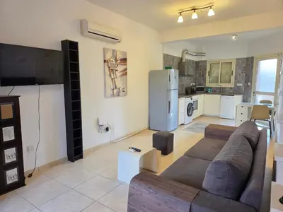 a large living room with a couch and a kitchen at Limassol Star 6 in Limassol