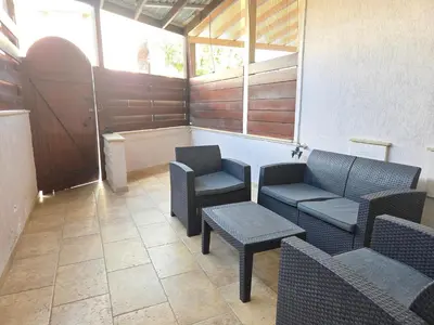a room with two chairs and a table and a tub at Limassol Star 6 in Limassol