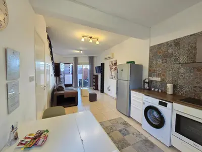 a kitchen with a white refrigerator and a table at Limassol Star 6 in Limassol