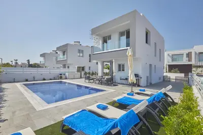 a villa with a swimming pool and a house at Protaras Pearl Villa Ekaterina in Protaras