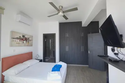 a bedroom with a bed and a flat screen tv at Protaras Pearl Villa Ekaterina in Protaras