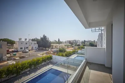 a balcony with a swimming pool and a view of a city at Protaras Pearl Villa Ekaterina in Protaras