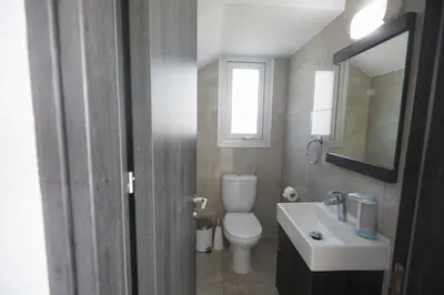 a bathroom with a toilet and a sink and a mirror at Protaras Pearl Villa Ekaterina in Protaras