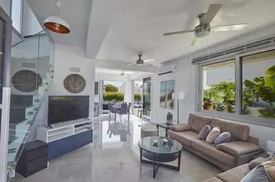 a living room with a couch and a tv at Protaras Pearl Villa Ekaterina in Protaras