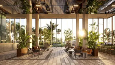 a lobby of a building with chairs and plants at The Nines in Ayia Napa