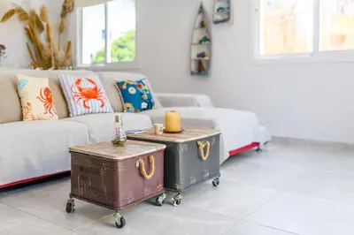 a living room with a couch and a table with a trunk at Villa Lela Serena by Ezoria Villas in Protaras