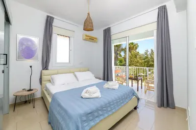a bedroom with a bed and a balcony at Villa Lela Serena by Ezoria Villas in Protaras