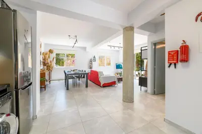 a living room with a red couch and a table at Villa Lela Serena by Ezoria Villas in Protaras