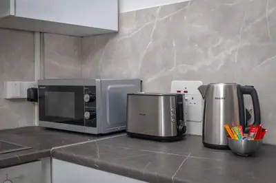 a kitchen counter with a microwave and a coffee maker at White Arches Apt #2 by TrulyCyprus in Limassol