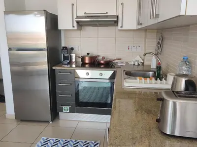 a kitchen with a stainless steel stove and a sink at Dream Vacation by the Sea Protaras in Protaras