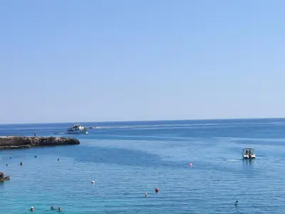 a group of people swimming in the water at Dream Vacation by the Sea Protaras in Protaras