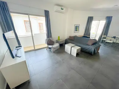 a living room with a couch and a table at High Speed Holiday Apartment in Larnaka