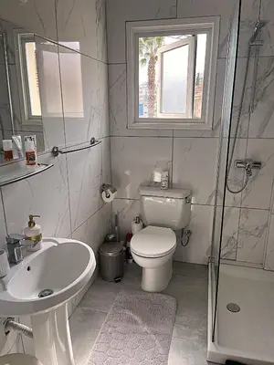 a bathroom with a toilet and a sink and a shower at Cyprus-Grecian Sea in Larnaka