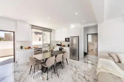 a kitchen and dining room with a table and chairs at Protaras Sol e Mar Villa 3 in Protaras