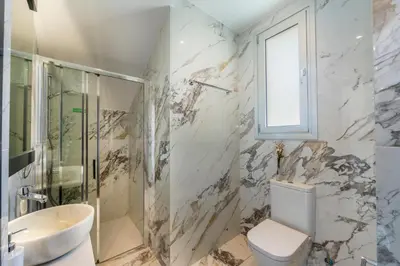 a bathroom with a toilet and a shower and a sink at Protaras Sol e Mar Villa 3 in Protaras