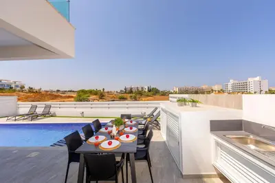 a patio with a table and chairs on a roof at Protaras Sol e Mar Villa 3 in Protaras