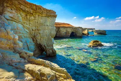 a view of the ocean with rocks in the water at Palm garden paradise in Pervolia