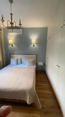 a bedroom with a large bed with white sheets at T&L Apartments Germasogia in Limassol