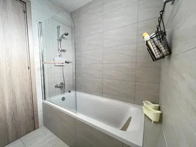 a bathroom with a white tub and a shower at Albert's apartment St. Lazarus 401 in Larnaka