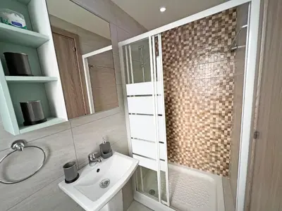 a bathroom with a white sink and a shower at Albert's apartment St. Lazarus 401 in Larnaka