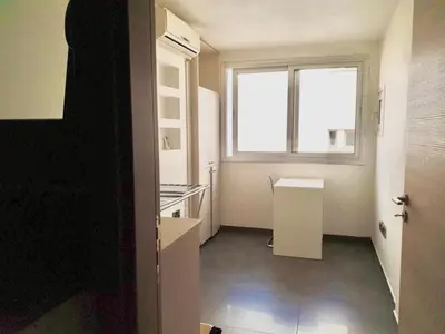a kitchen with a window and a sink and a table at 2-bedroom appartment in center in Nicosia