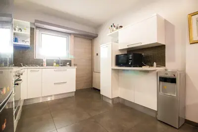a kitchen with white cabinets and a window at 2-bedroom appartment in center in Nicosia