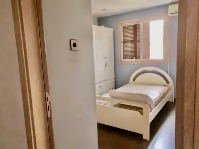 a small room with a bed and a window at 2-bedroom appartment in center in Nicosia