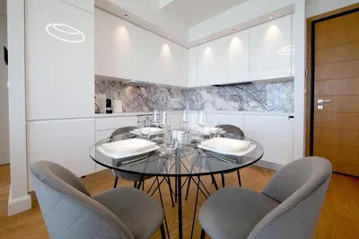 a dining room with a glass table and chairs at Sky Tower in Limassol