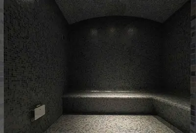 a dark room with a bench in the corner at Sky Tower in Limassol