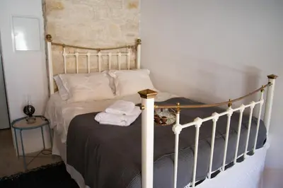 a bedroom with a bed with a wooden frame at Cleo's Inn in Lofou