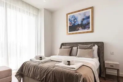 a bedroom with a large bed with towels on it at Del Mar Beachfront 'C' 2 Bedroom Residence in Limassol