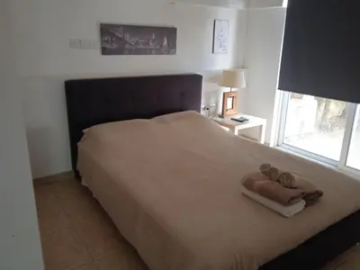 a bedroom with a large bed with towels on it at Nicosia rest and relax 1 bedroom apartment in Nicosia