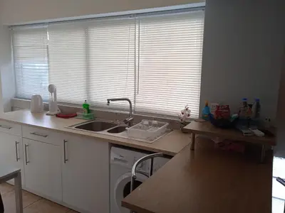 a kitchen with a sink and a washing machine at Nicosia rest and relax 1 bedroom apartment in Nicosia