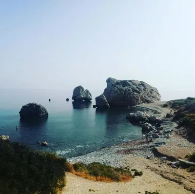 a beach with some rocks in the water at Bay Cottage Beautiful cosy luxury cottage - Beach area in Pissouri