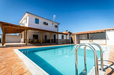 a swimming pool in front of a house at Reel Paradise Villa, Cyprus in Larnaka