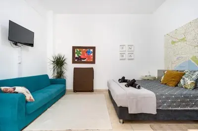 a living room with a couch and a bed at Cozy and Traditional - EC Studios in Larnaka