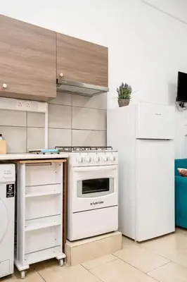 a kitchen with a white stove and a refrigerator at Cozy and Traditional - EC Studios in Larnaka